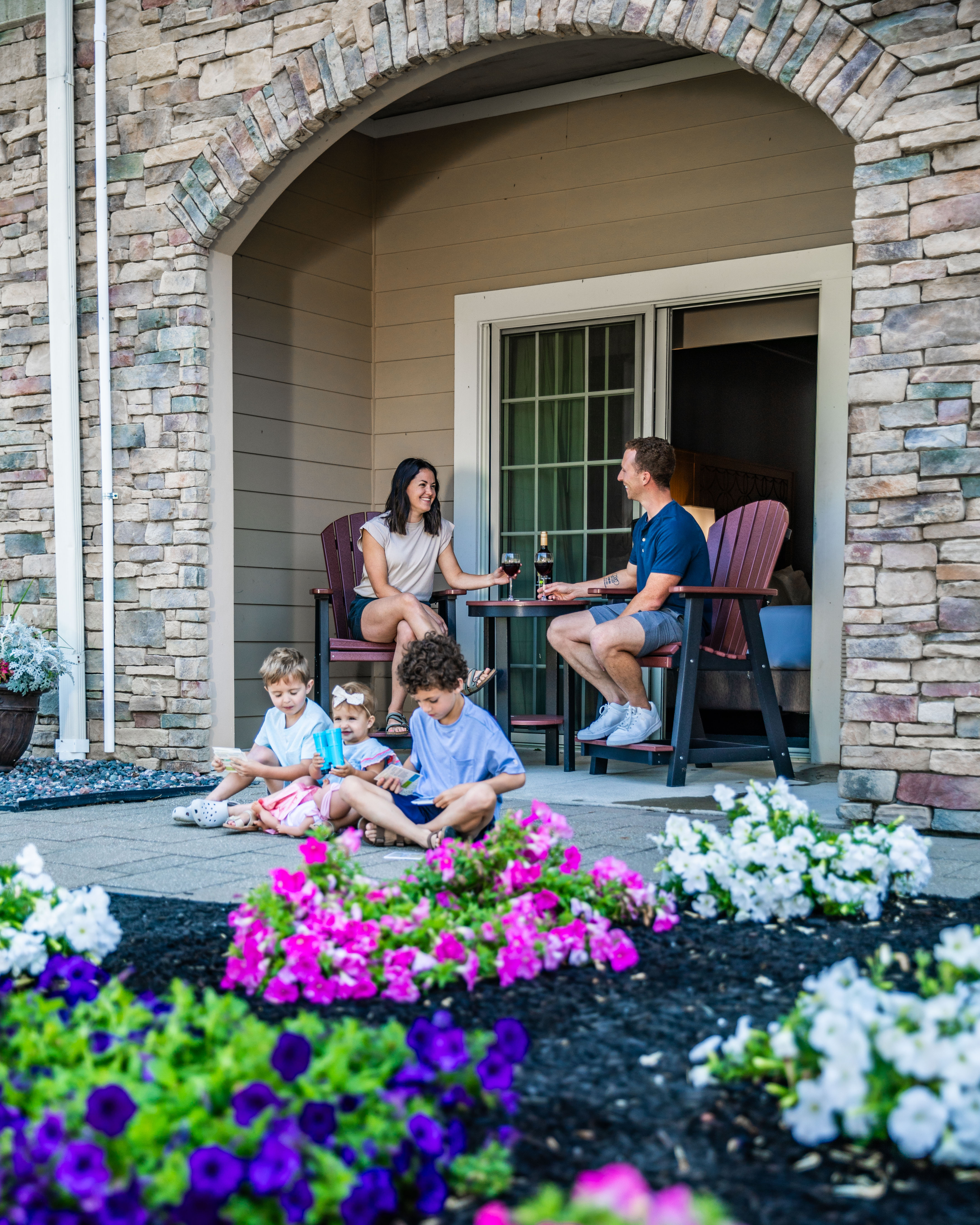 A family relaxing outside their room at The Lodge at Geneva