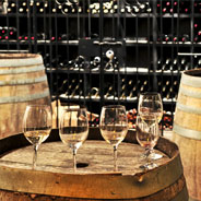 Wine glasses on top of a barrel in a wine cellar